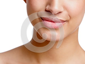Her smile can charm anyone. Closeup studio shot of a beautiful young womans mouth.