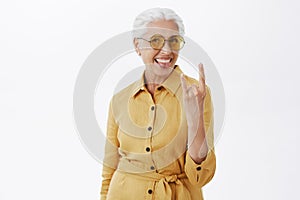 Her sould is young. Portrait of joyful pleased and carefree enthusiastic grandmother with grey hair in stylish