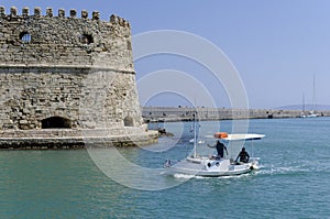 Heraklion, crete / Greece: Fishermen with their traditional fishing boat in front of the fortress Koules