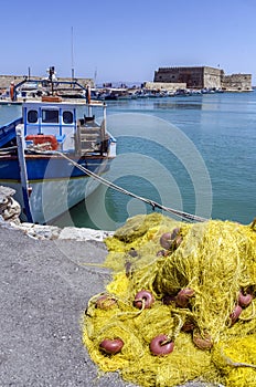 Heraklion, Crete / Greece: Fishing nets, Fishing boat in front of fortress Koules in Heraklion