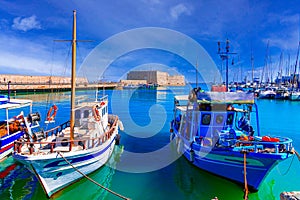 Heraklion, Crete island, Greece: Panoramic view with boats and The Koules or Castello a Mare in the background - a