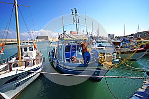 Heraklion, Greece, September 25, 2018, A fisherman sets up his fishing nets on his boat in the port