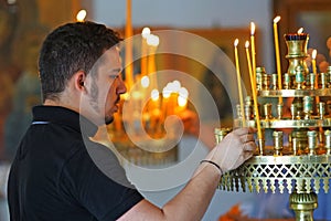 Heraklion, Greece, 25 September 2018, A person lights candles in the cathedral of Agios Minas (Saint Minas