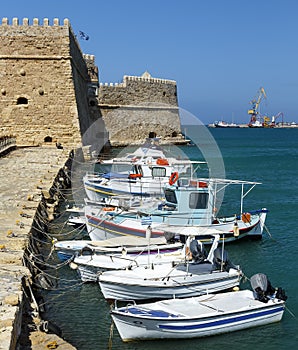 Heraklion old venetian harbour with colorful small fishing boats, yachts and ships, Heraclion Crete, Greece