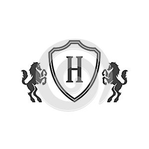 Heraldic horses and monogram on shield isolated on white background