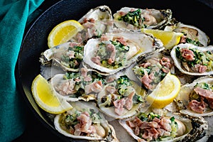 Herb Butter Oysters with Prosciutto in a Cast-Iron Skillet