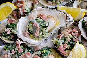 Herb Butter Oysters with Prosciutto in a Cast-Iron Skillet