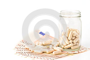 Herb capsule pills spilling out off bottle  isolated on white background.