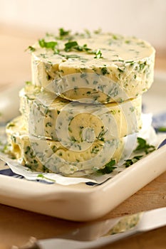 Herb flavored butter pats with fresh parsley