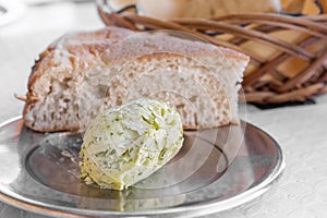Herb-flavoured butter with bread photo