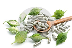 Herb pills with bitter gourd ,homeopathic medicine on white back