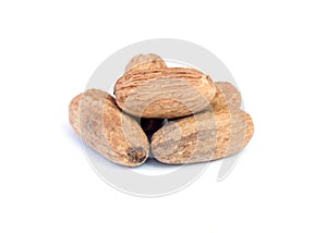 Nutmeg on wooden over white background. photo