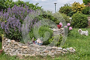 Herb spiral in the colorful garden