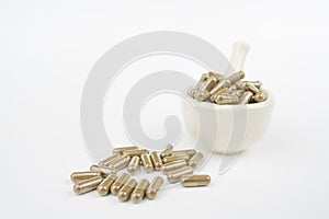 Herbal capsule and mortar on bluee background