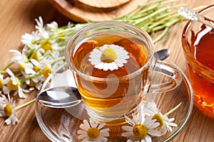 Herbal chamomile tea on wooden flooring