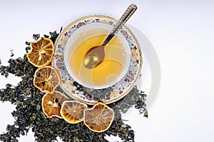 Herbal cup of tea with leaves and lemons