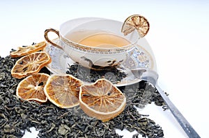 Herbal cup of tea with leaves and lemons