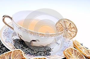 Herbal cup of tea with leaves and lemons