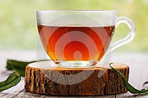 Herbal drink Ivan-tea in transparent cup close-up