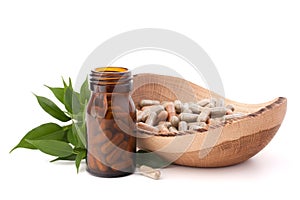 Herbal drug capsules in brown glass bottle. Alternative medicine