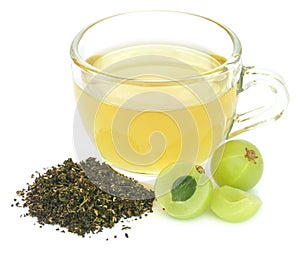 Herbal green tea in a cup with amla fruits