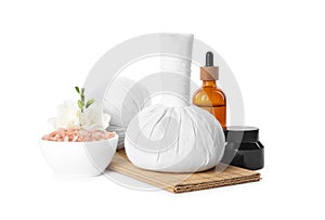 Herbal massage bags and different spa products on white background