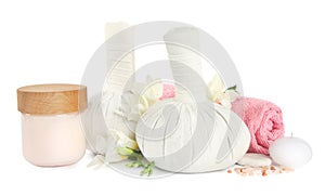 Herbal massage bags and other spa products on white background