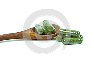 Herbal medicine capsules spilling out of a bottle