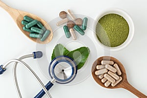 Herbal medicine in capsules with stethoscope