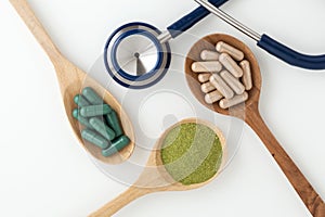 Herbal medicine in capsules with stethoscope