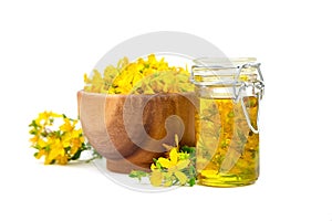 Herbal medicine - Hypericum perforatum, St Johns wort or tutsan herb oil with flowers isolated on white photo