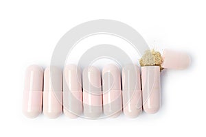 Herbal medicine powder capsule on white background