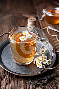 Herbal medicine for respiratory health, a cup of daisy tea with honey