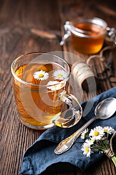 Herbal medicine for respiratory health, a cup of daisy tea with honey