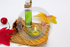 Herbal oils, candle aromatherapy for health care with maple leaf in autumn season