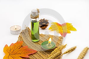 Herbal oils, candle aromatherapy for health care with maple leaf in autumn season