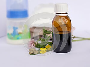 Herbal pills and homeopatic syrop on a white background. Closeup