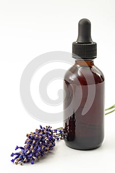 Herbal remedies, holistic health care and alternative medicine concept theme with pipette or glass dropper in a brown bottle of