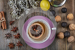 Herbal sage tea with dried sage leaves on wooden rustic background. Herbal tea hot drink concept