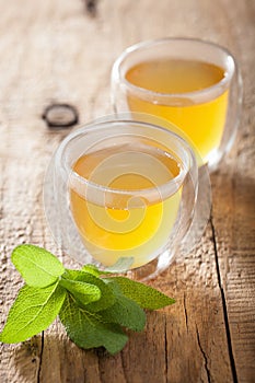 Herbal sage tea with green leaves in glass cups