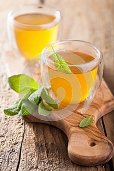 Herbal sage tea with green leaves in glass cups