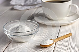 Herbal sweetener stevia in spoon and a cup of coffee