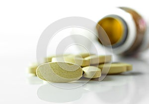 Herbal tablets , Medicine out of pill bottle on white background