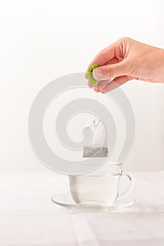 Herbal tea bag over the Cup with hot water