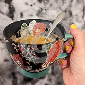 Herbal tea in a beautiful mug marbled ink background