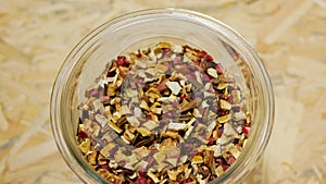 Herbal tea dried blend of rose glass jar cup, apple, lemon peel, cranberry, orange peel, star anise winter punch, cloves