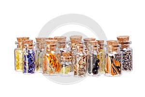 Herbal tea, dried herbs, flowers and berries in glass bottles for medical use on white background