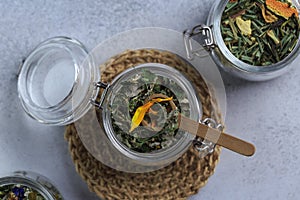 Herbal tea in glass pot on grey