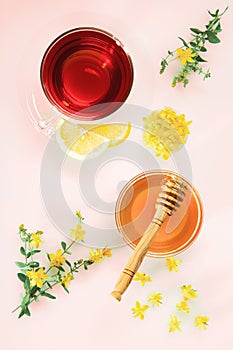 Herbal tea, honey, lemon and fresh flowers of Saint John`s wort