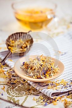 Herbal tea with infuser and cup of tea